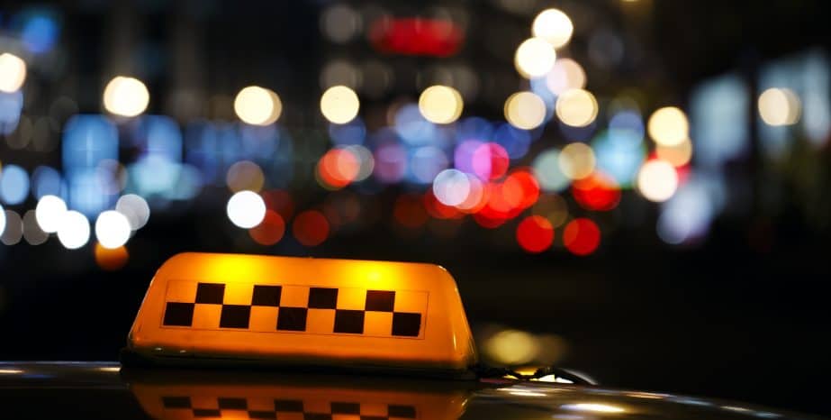 Hakiminjurylaw Illuminated taxi cab sign on a city street