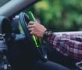 Hakiminjurylaw: asian-man-holds-beer-bottle-while-is-driving-car
